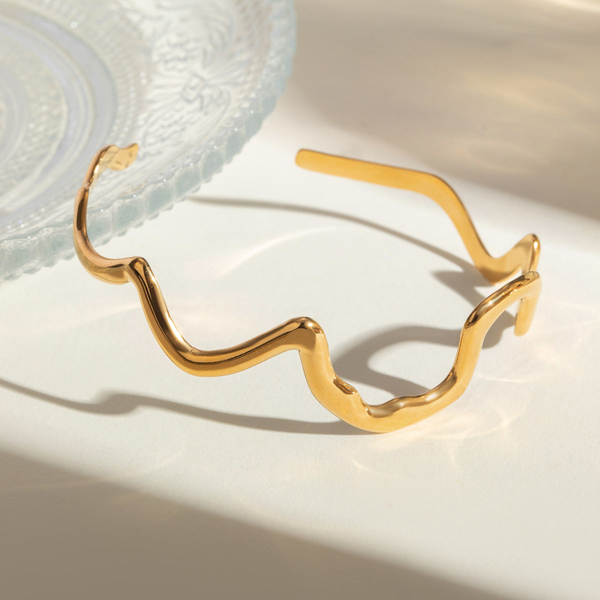 Gold wavy adjustable bracelet (6.1cm diameter, 0.4cm width) shown on wrist 2