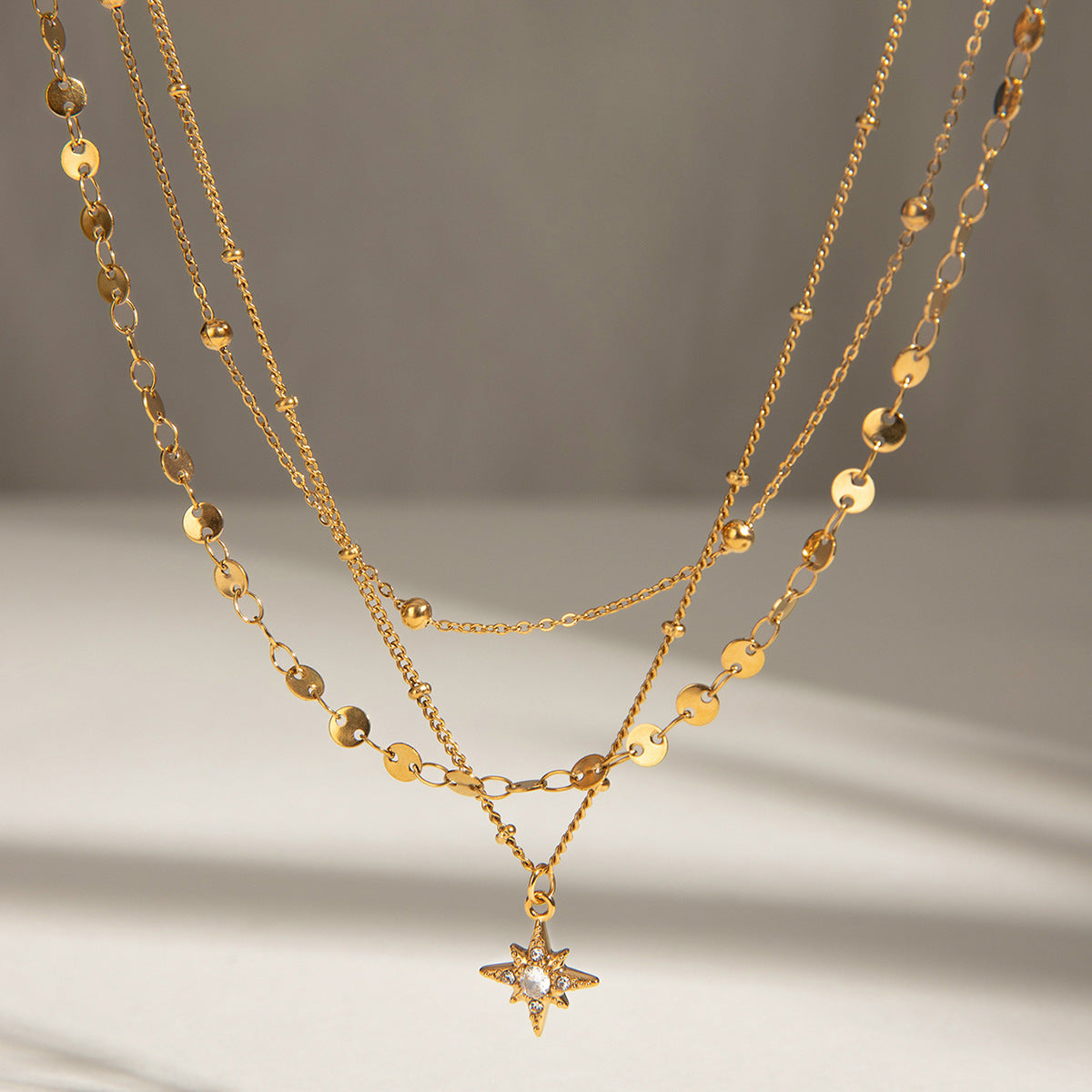 Three gold layered necklaces (40+5cm, 41.5+5cm, 43+5cm) with 1.43cm coin charm, shown in boho styling 2
