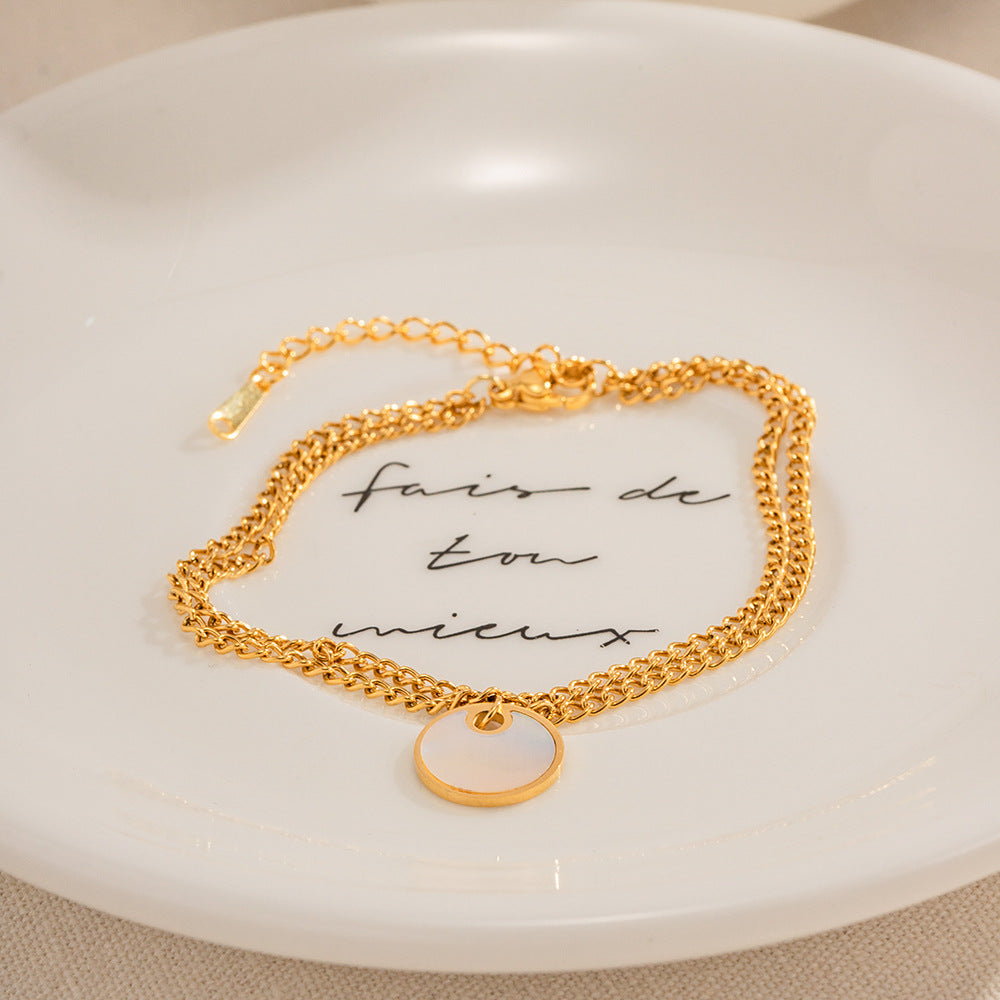 Delicate gold adjustable bracelet (17.5+4cm) with 1.27cm mother-of-pearl charm shown on wrist 2