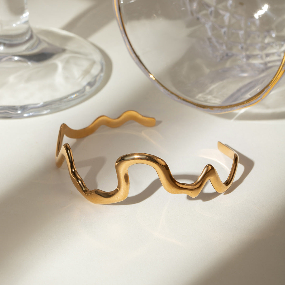 Gold wavy adjustable bracelet (6.1cm diameter, 0.4cm width) shown on wrist 3