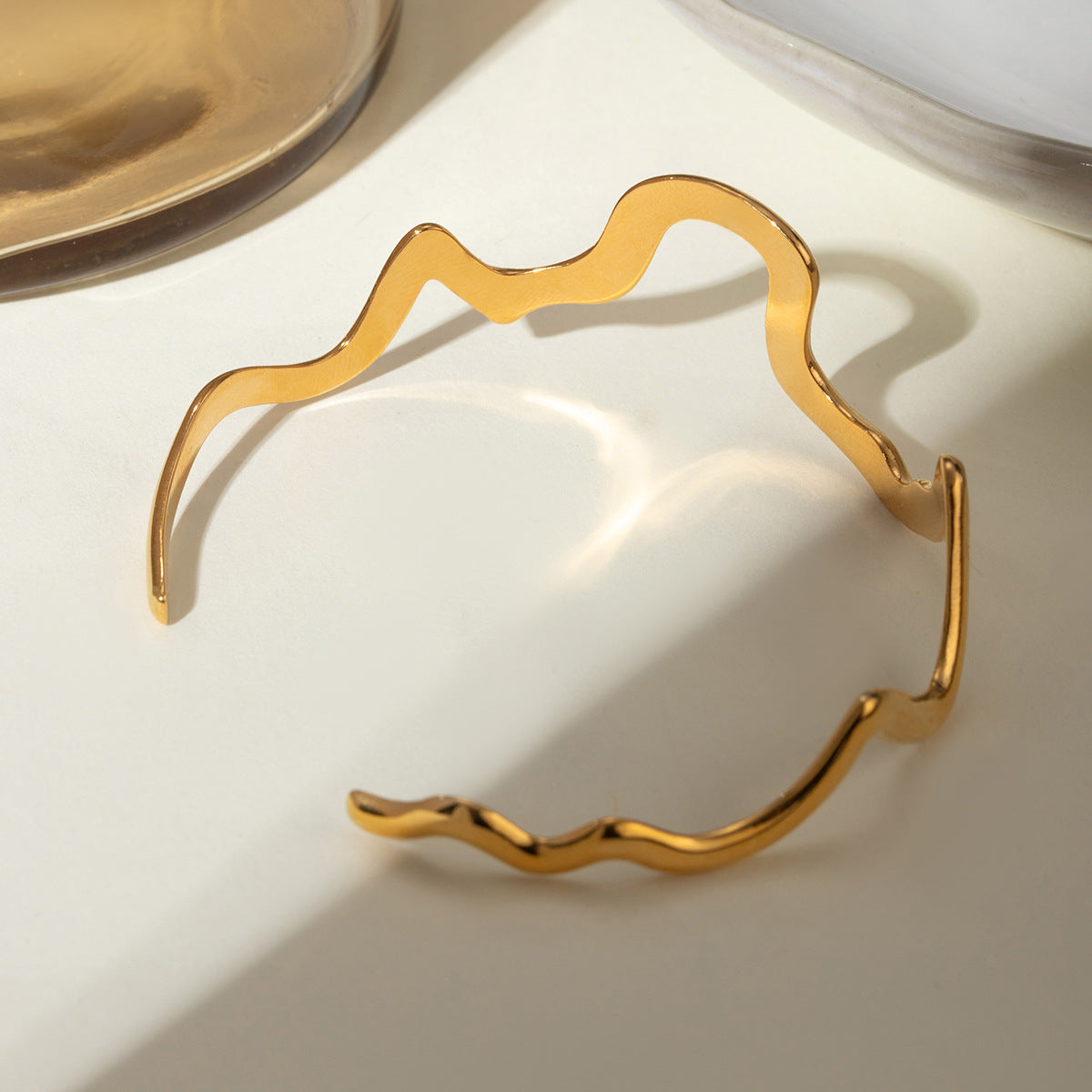 Gold wavy adjustable bracelet (6.1cm diameter, 0.4cm width) shown on wrist 4