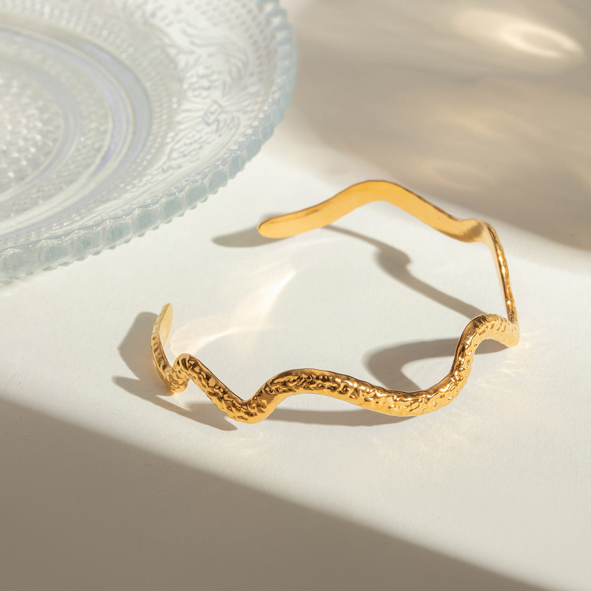Gold wavy adjustable bracelet (6.1cm diameter, 0.4cm width) shown on wrist 6
