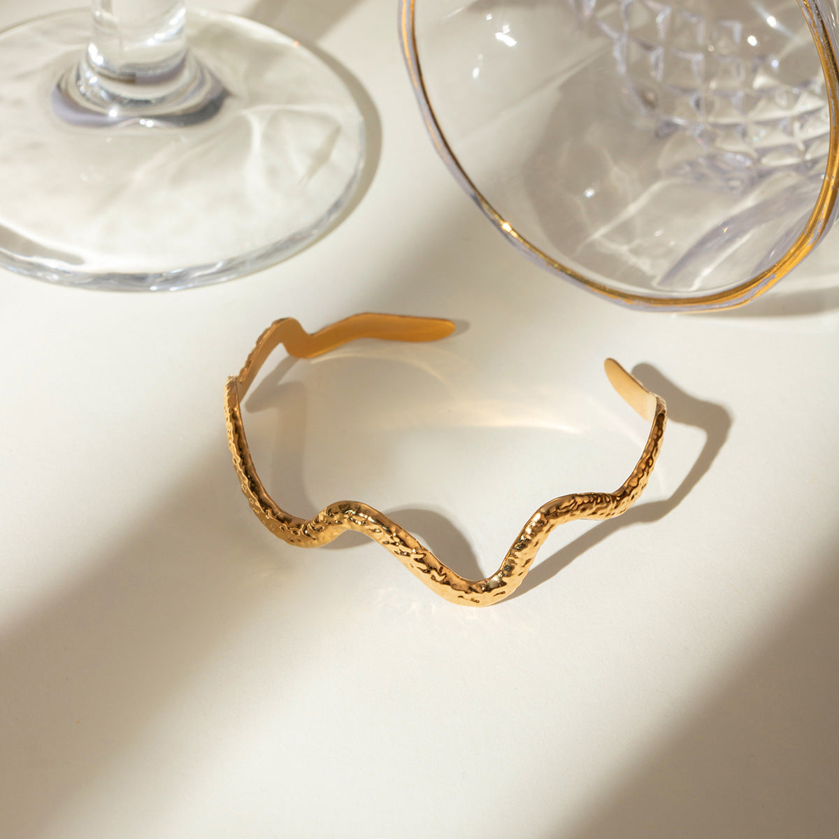 Gold wavy adjustable bracelet (6.1cm diameter, 0.4cm width) shown on wrist 7