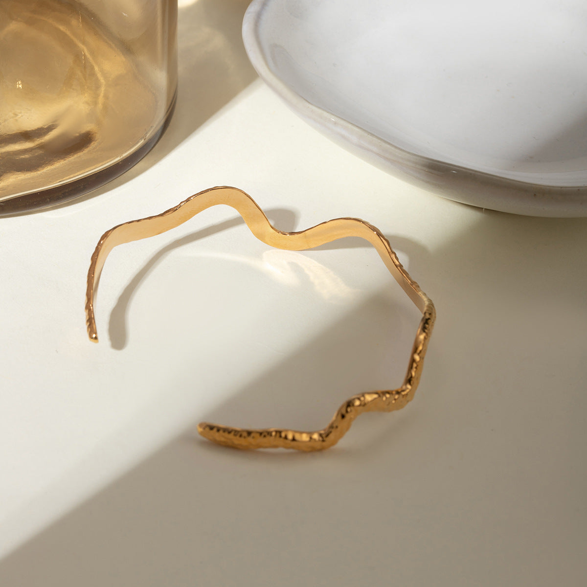 Gold wavy adjustable bracelet (6.1cm diameter, 0.4cm width) shown on wrist 8