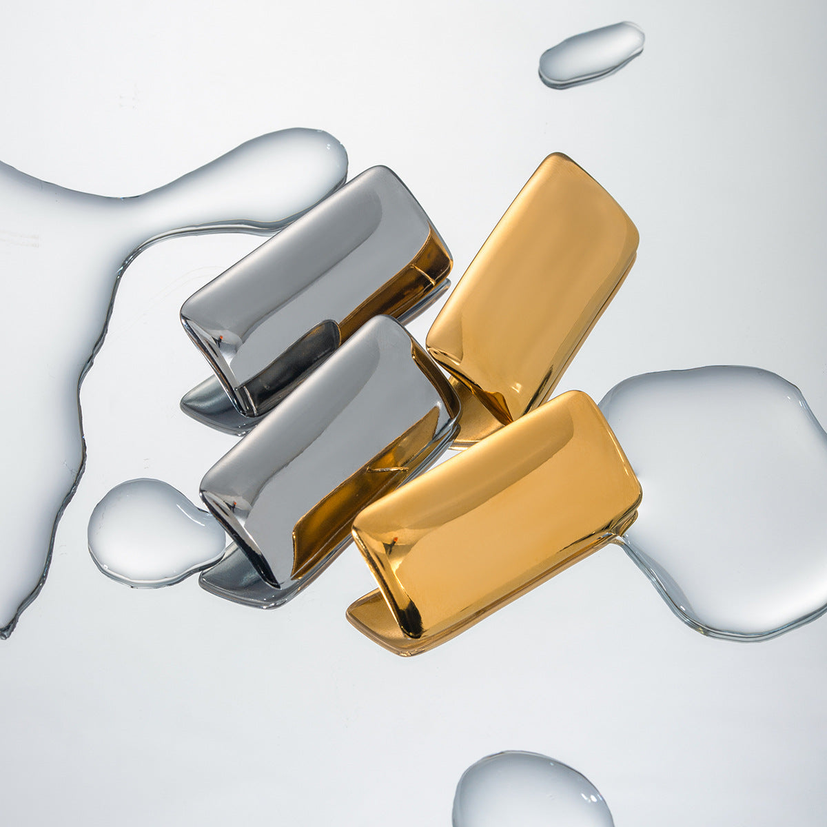 Close-up view of Arza's two-tone geometric rectangle earrings showing gold and silver metal detailing (4.4cm statement jewelry) - 18