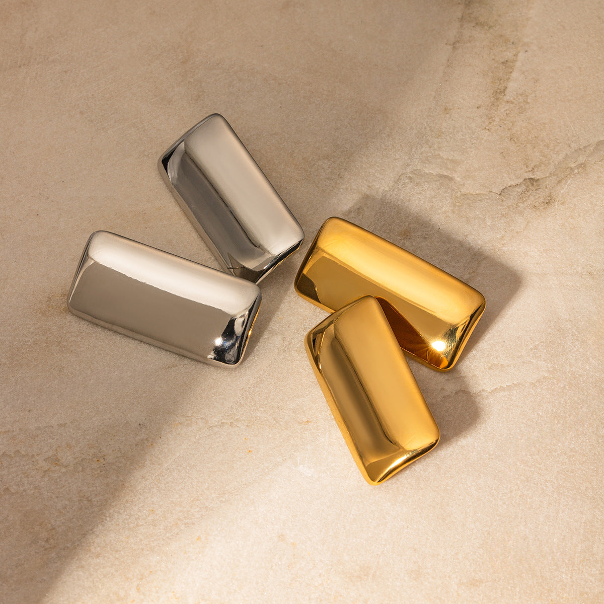 Close-up view of Arza's two-tone geometric rectangle earrings showing gold and silver metal detailing (4.4cm statement jewelry) - 12