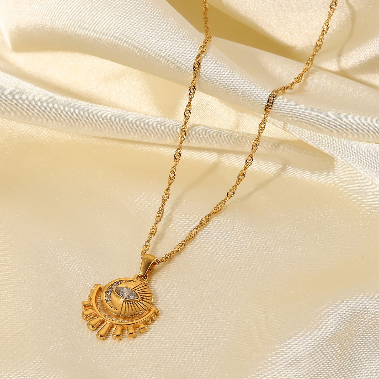 Gold-tone sun pendant necklace with layered chain, adjustable length, and trendy design for women. 2