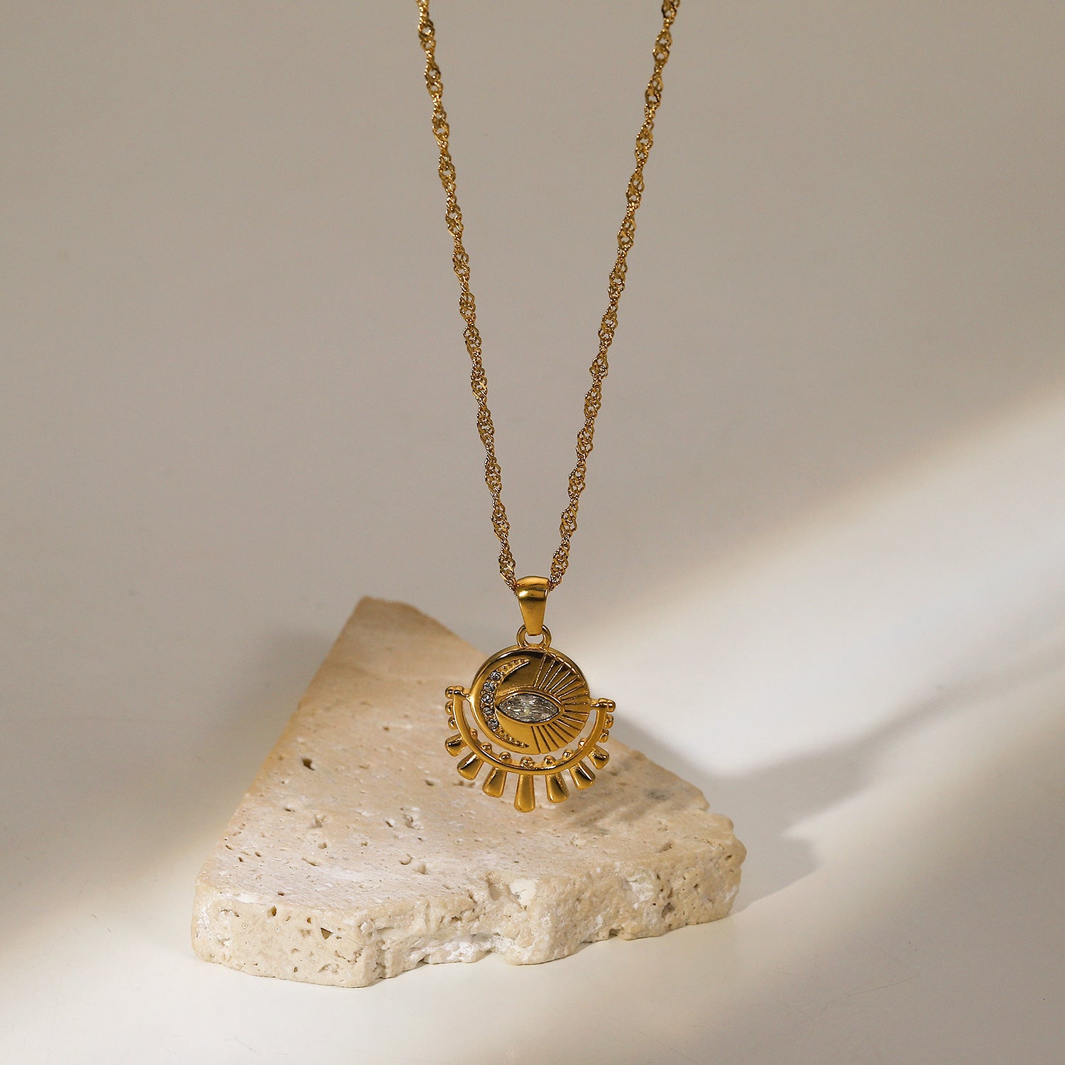 Gold-tone sun pendant necklace with layered chain, adjustable length, and trendy design for women. 3