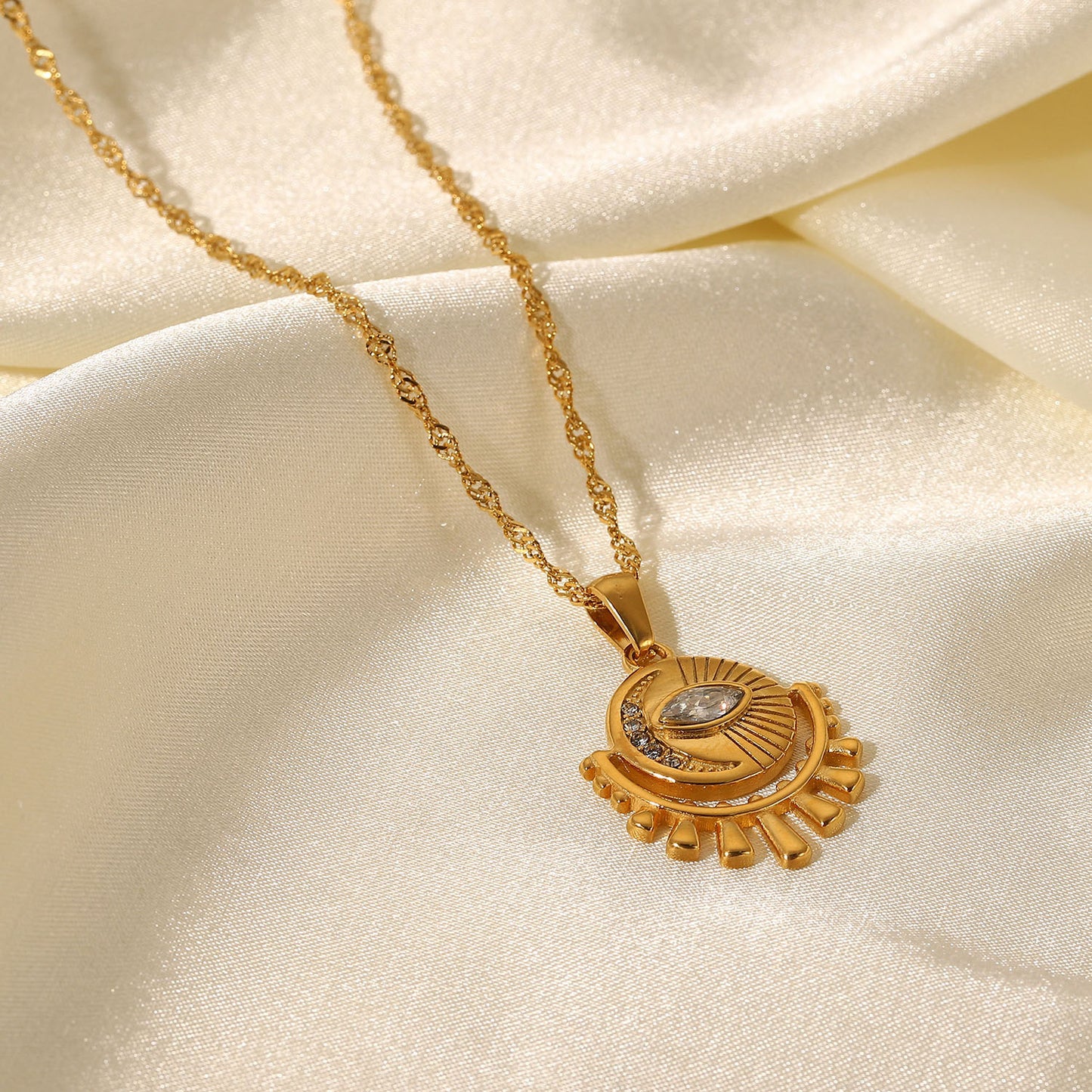 Gold-tone sun pendant necklace with layered chain, adjustable length, and trendy design for women. 4