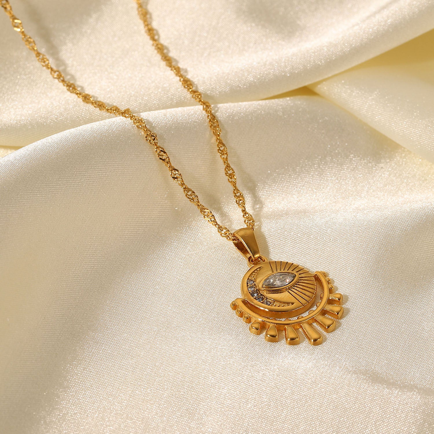 Gold-tone sun pendant necklace with layered chain, adjustable length, and trendy design for women. 4