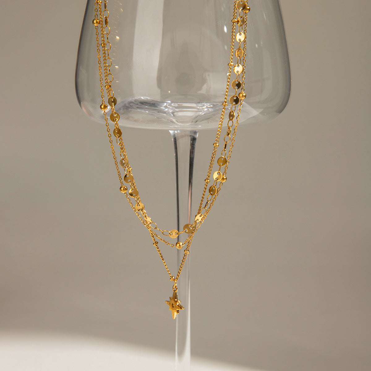 Three gold layered necklaces (40+5cm, 41.5+5cm, 43+5cm) with 1.43cm coin charm, shown in boho styling 1