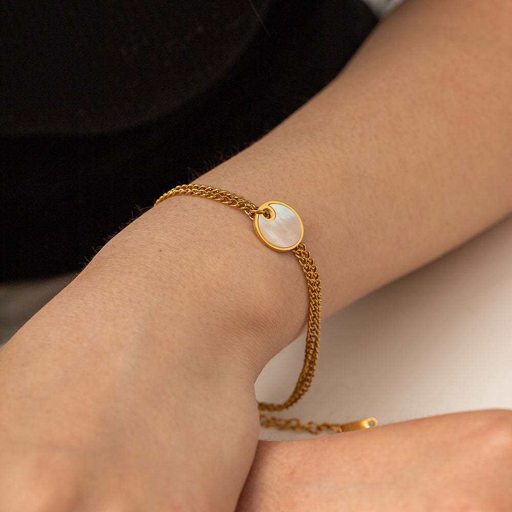 Delicate gold adjustable bracelet (17.5+4cm) with 1.27cm mother-of-pearl charm shown on wrist 1