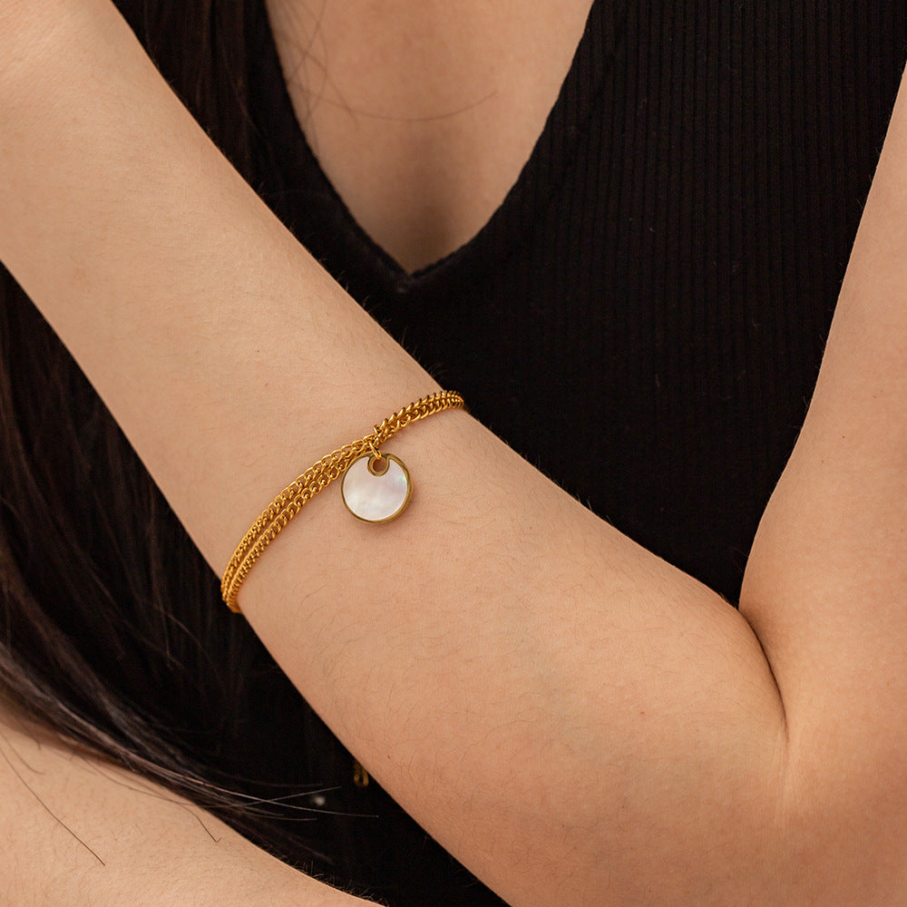 Delicate gold adjustable bracelet (17.5+4cm) with 1.27cm mother-of-pearl charm shown on wrist 3