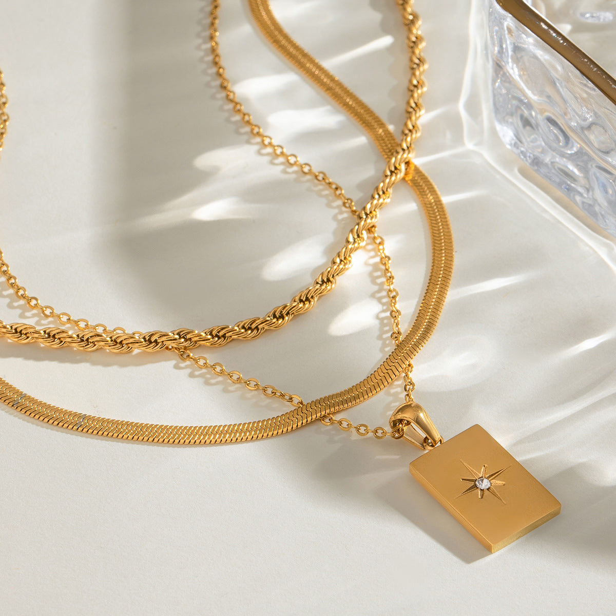 Gold rectangular charm necklace shown at three adjustable lengths (15.7-17.7in) with 20.9g stainless steel chain 5